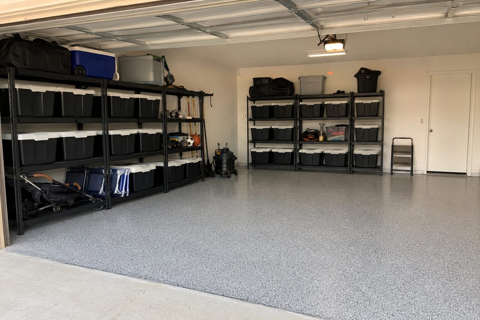 Full Transformation garage with an epoxy floor, heavy-duty freestanding racks, and coordinated storage bins
